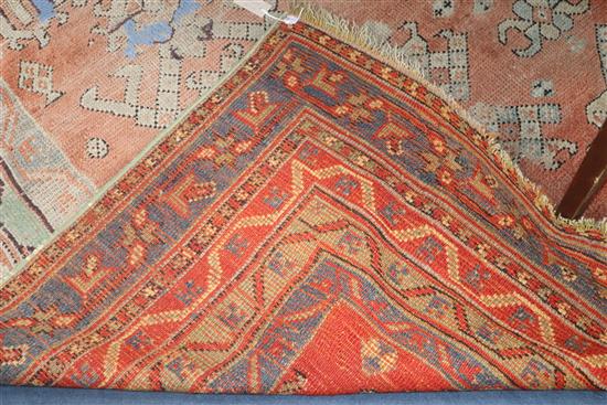 A Turkish red ground carpet 380 x 321cm (worn)